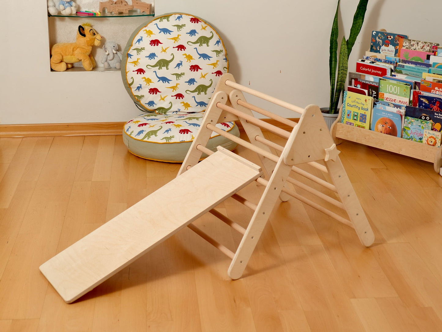 Montessori indoor playground with Pikler triangle and slide, perfect for toddler learning and play.