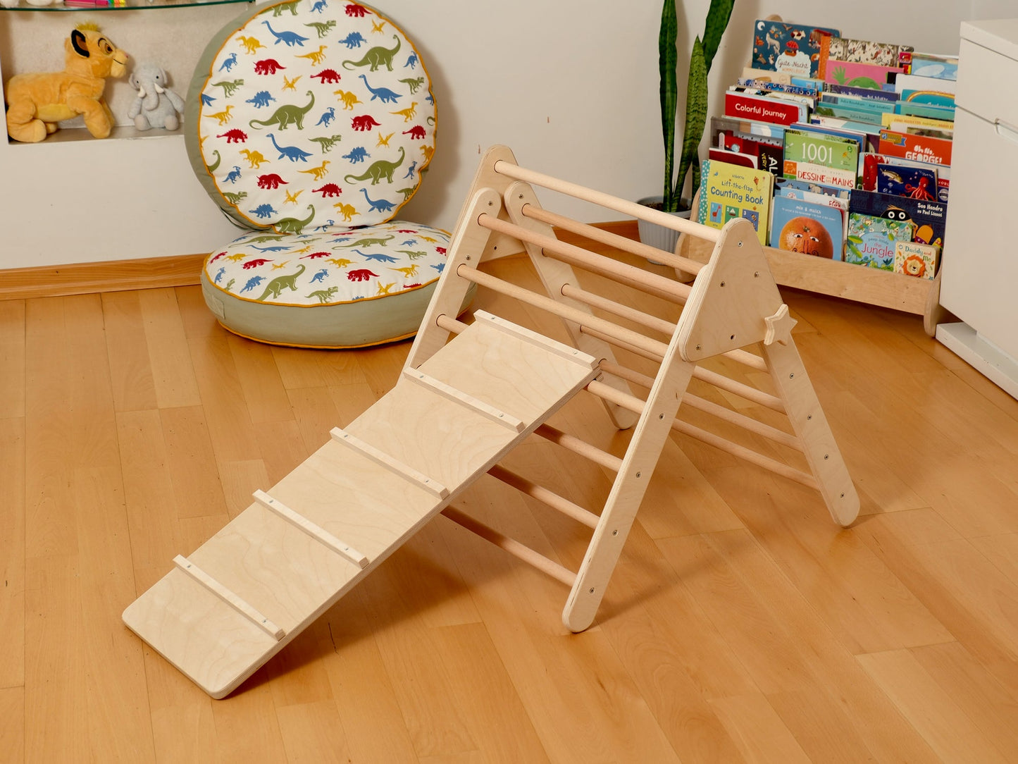 Montessori indoor playground set featuring a Pikler triangle, climbing arch, and slide for toddler fun.