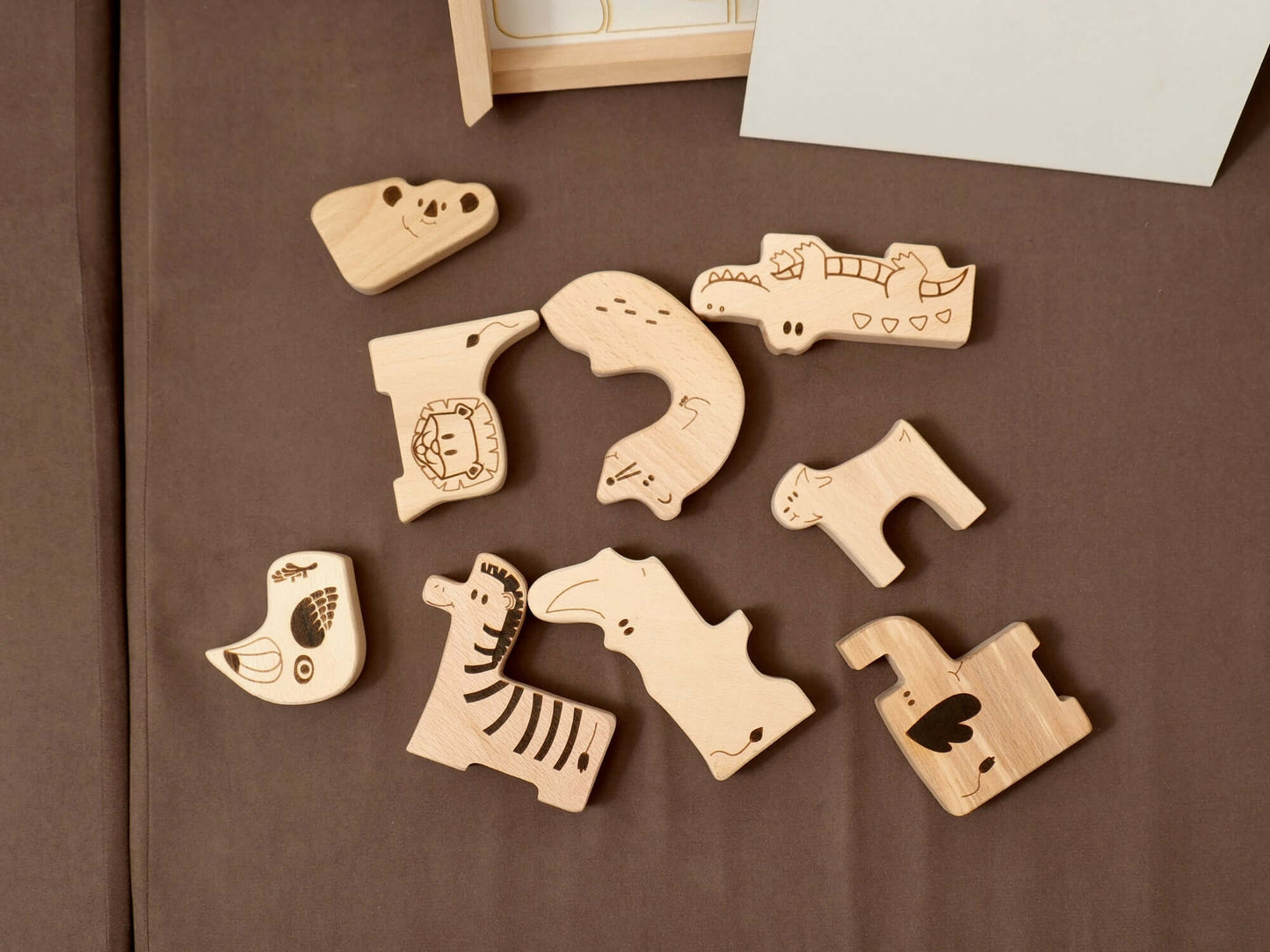 Handcrafted wooden safari animal puzzle pieces for toddlers promoting learning and creativity.