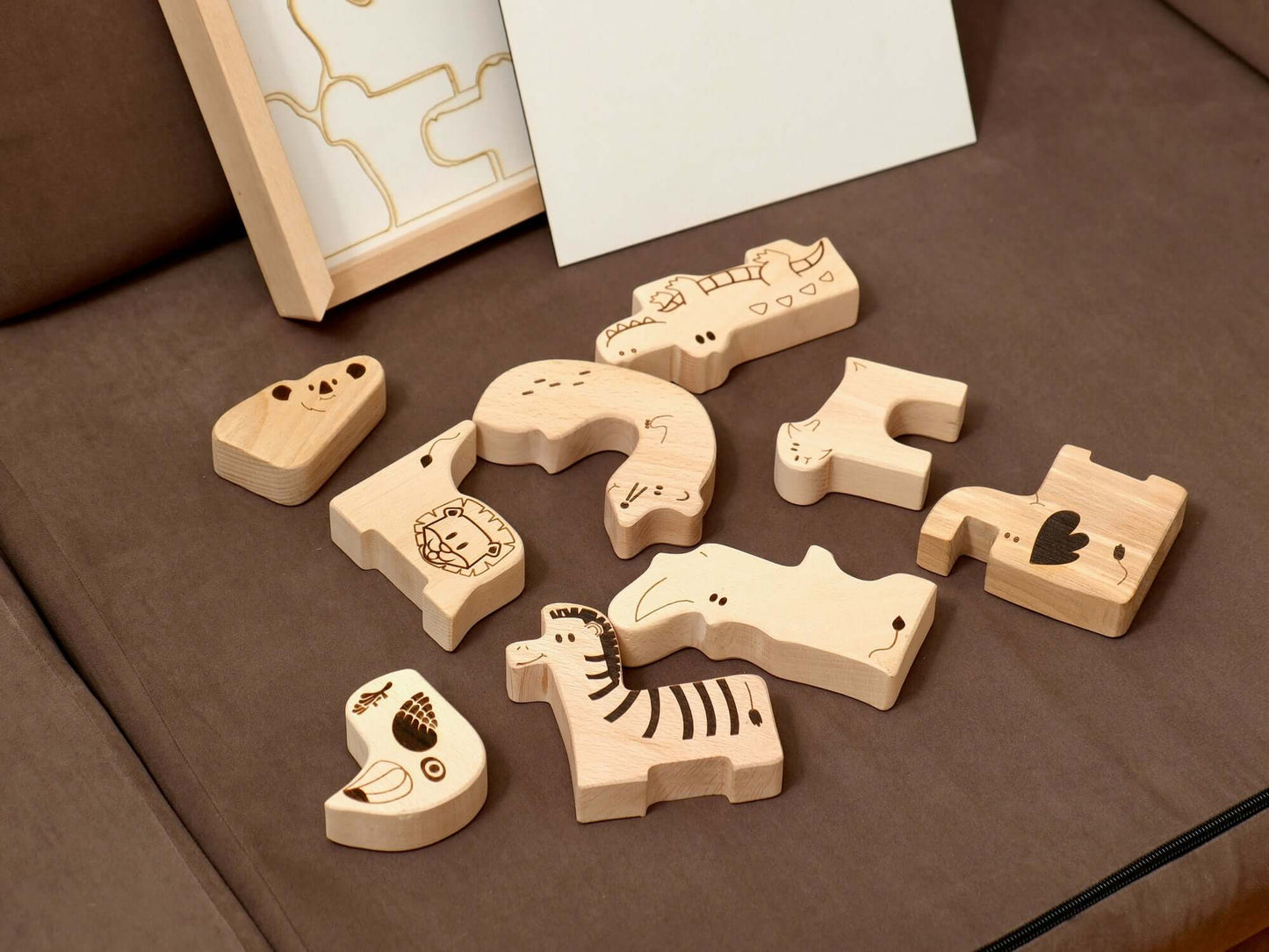 Wooden safari animal puzzle pieces for toddlers, ideal for Montessori-inspired learning and play.