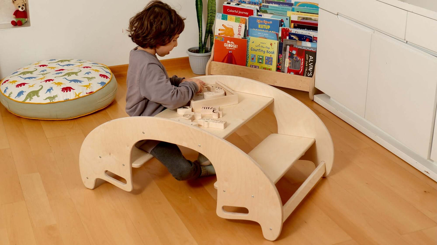 Toddler playing with a wooden puzzle at a Montessori-inspired learning table in a cozy playroom.