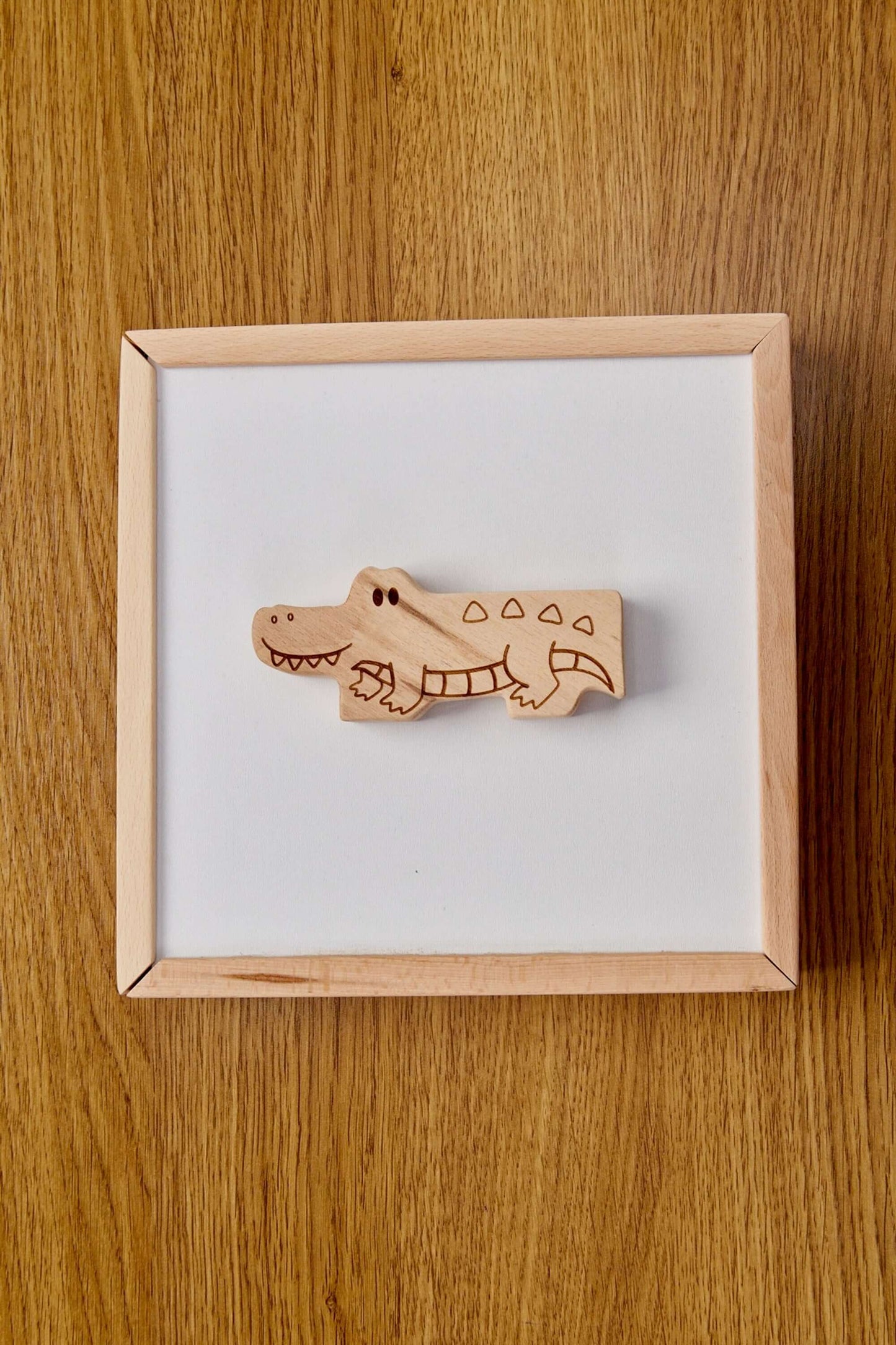 Handcrafted wooden crocodile piece from a toddler puzzle box, perfect for Montessori-inspired learning play.