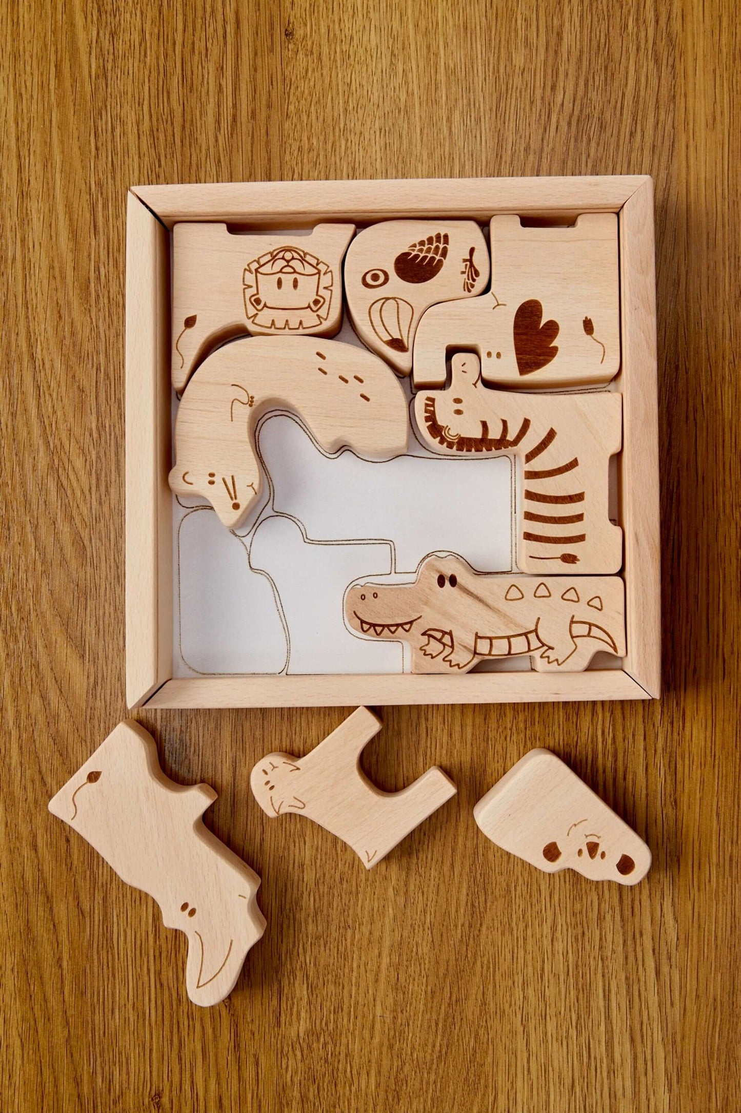 Wooden safari animal puzzle box with cute animal shapes for toddlers' learning play.