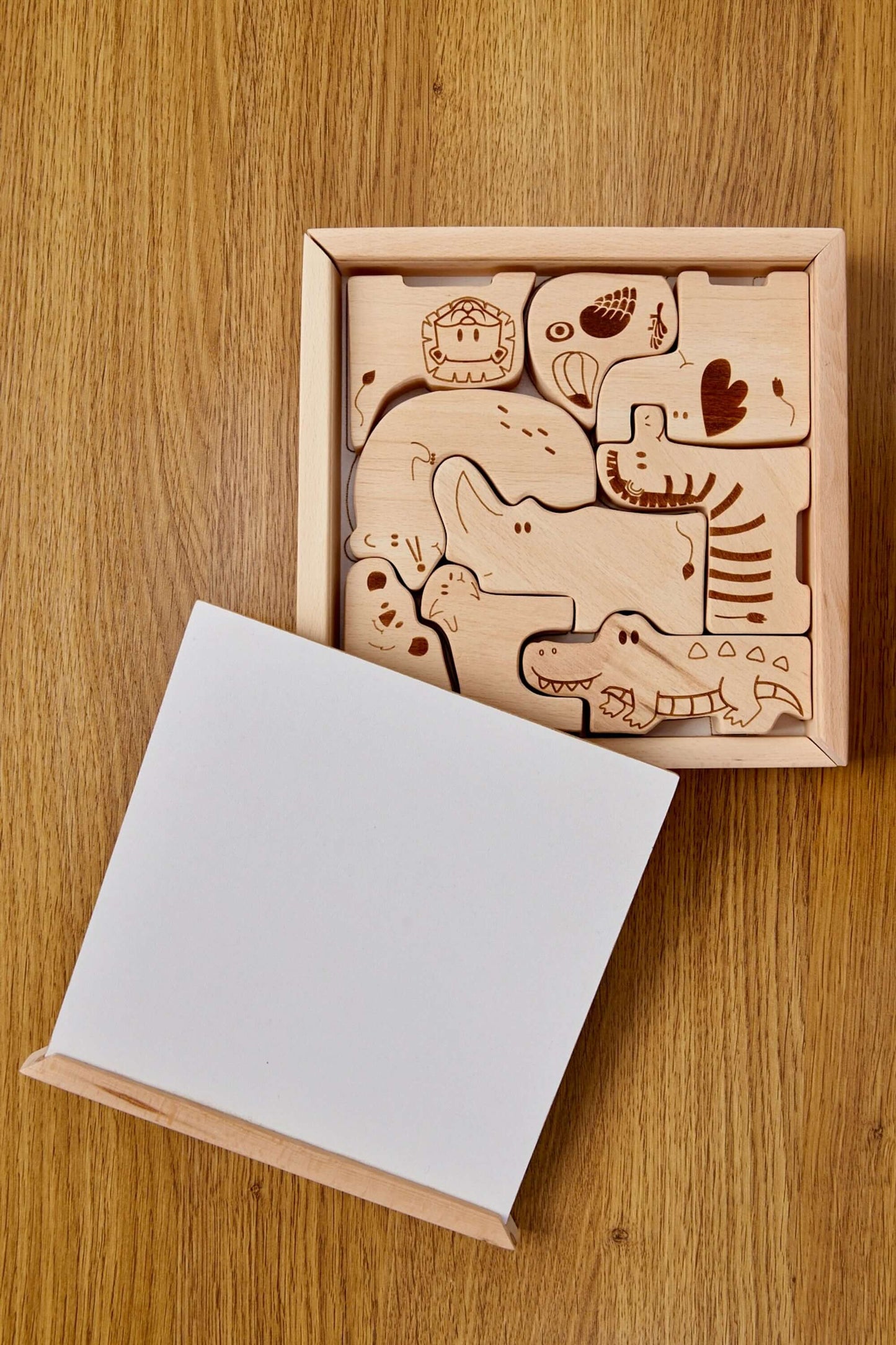 Wooden Safari Animal Puzzle Box for toddlers featuring handcrafted animal pieces on a wooden base.