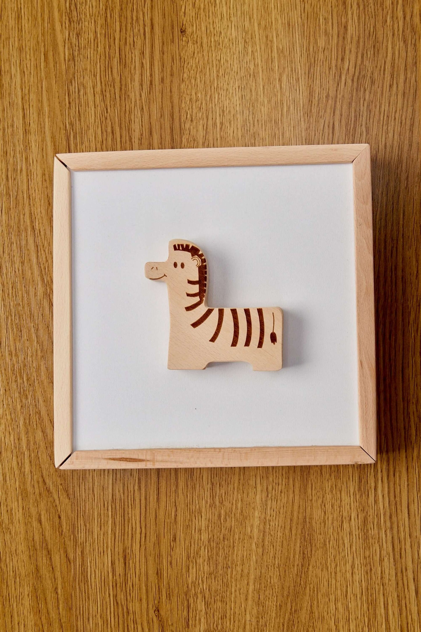 Wooden zebra puzzle piece on a white background, perfect for toddlers' learning and play.