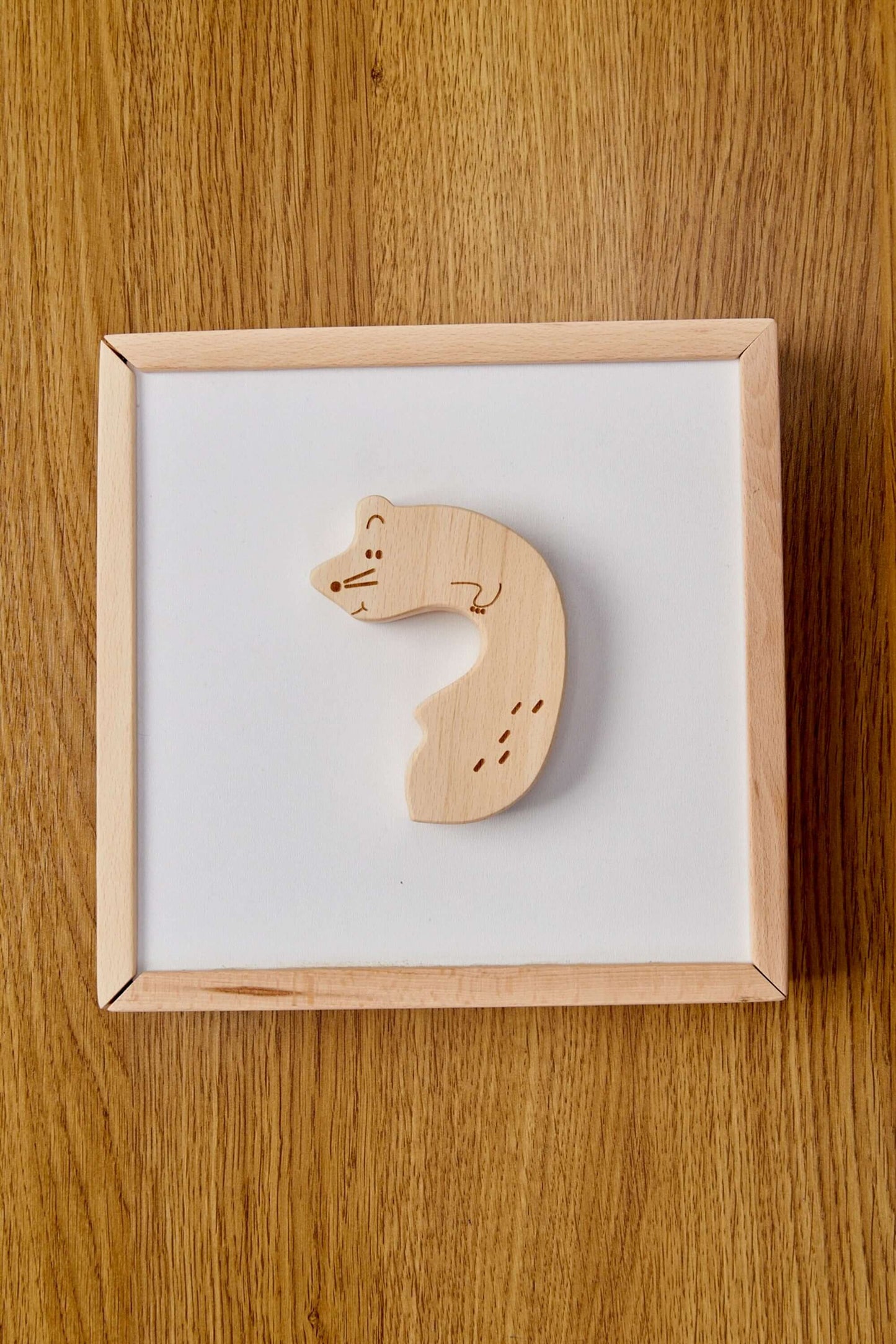 Handcrafted wooden animal puzzle piece on a simple white background, perfect for toddler learning.