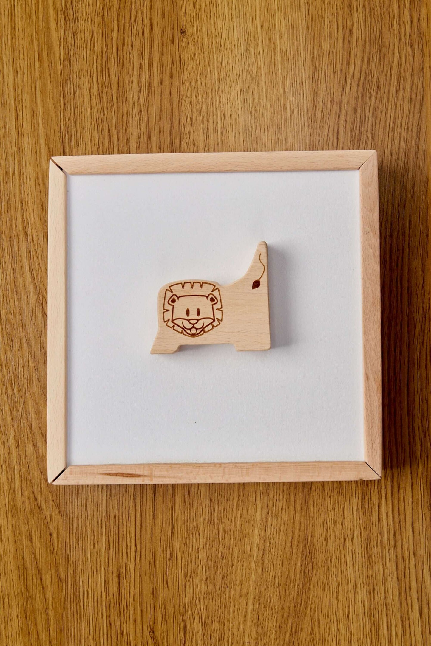 Wooden lion puzzle piece from the safari animal puzzle box, designed for toddlers' hands-on learning.