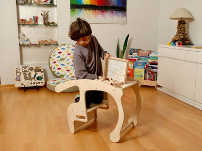 Toddler engaged with a wooden safari animal puzzle box, promoting hands-on learning and fun in a playful indoor environment.
