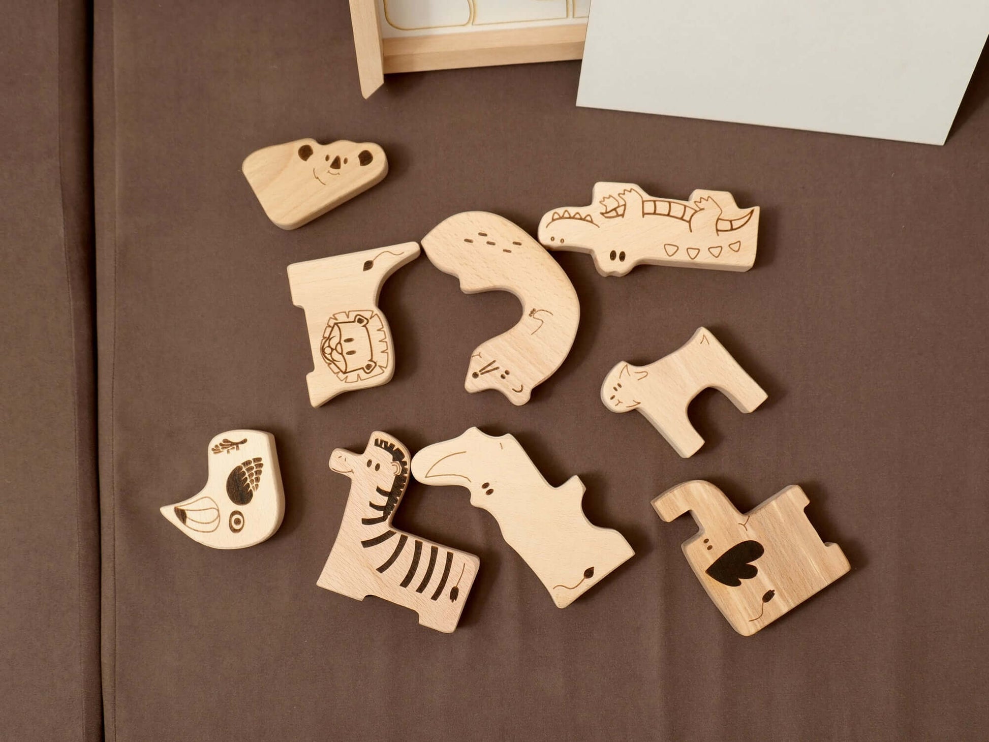 Handcrafted wooden safari animal puzzle pieces for toddlers promoting learning and creativity.